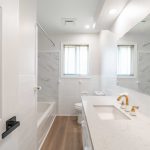 After image of a newly renovated washroom with bright lighting and clean, sleek, and modern finishes