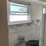 Before image of a kitchen renovation with torn out cabinetry