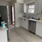 Newly renovated kitchen with new stainless steel appliances and modern cabinetry and tiling